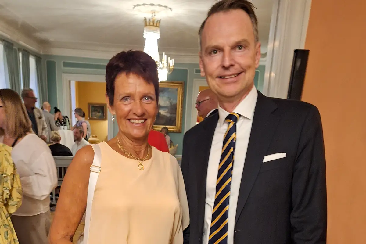 Lillian Håkansson med kastanjebrunt kortklippt hår står bredvid landshövding Peter Danielsson i kostym.